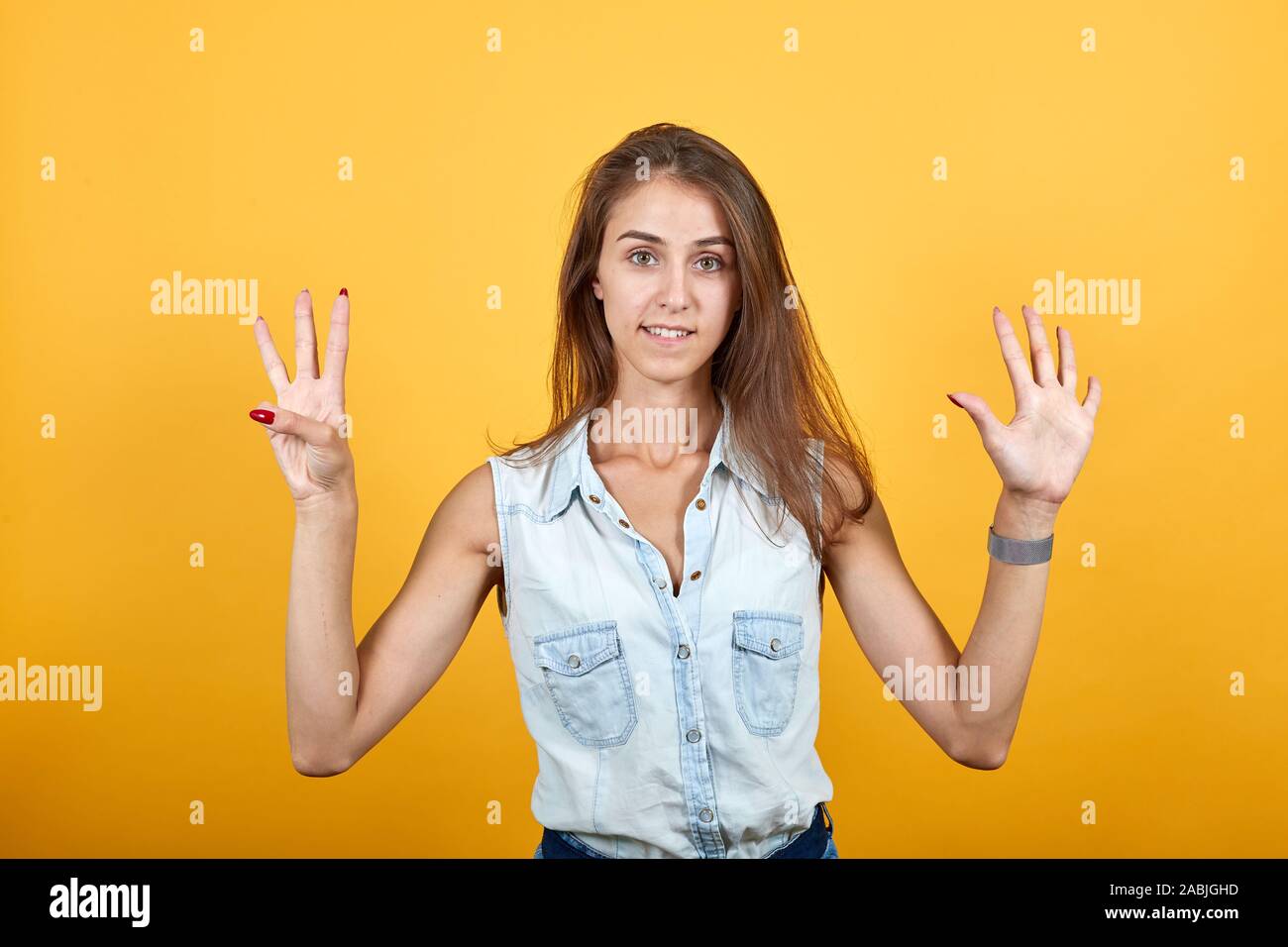 Crazy Caucasian Young Woman In Blue Denim Shirt Shoving Nine Fingers
