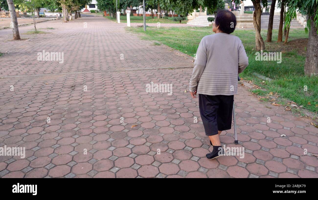 Mature woman alone walking sidewalk hi-res stock photography and images ...