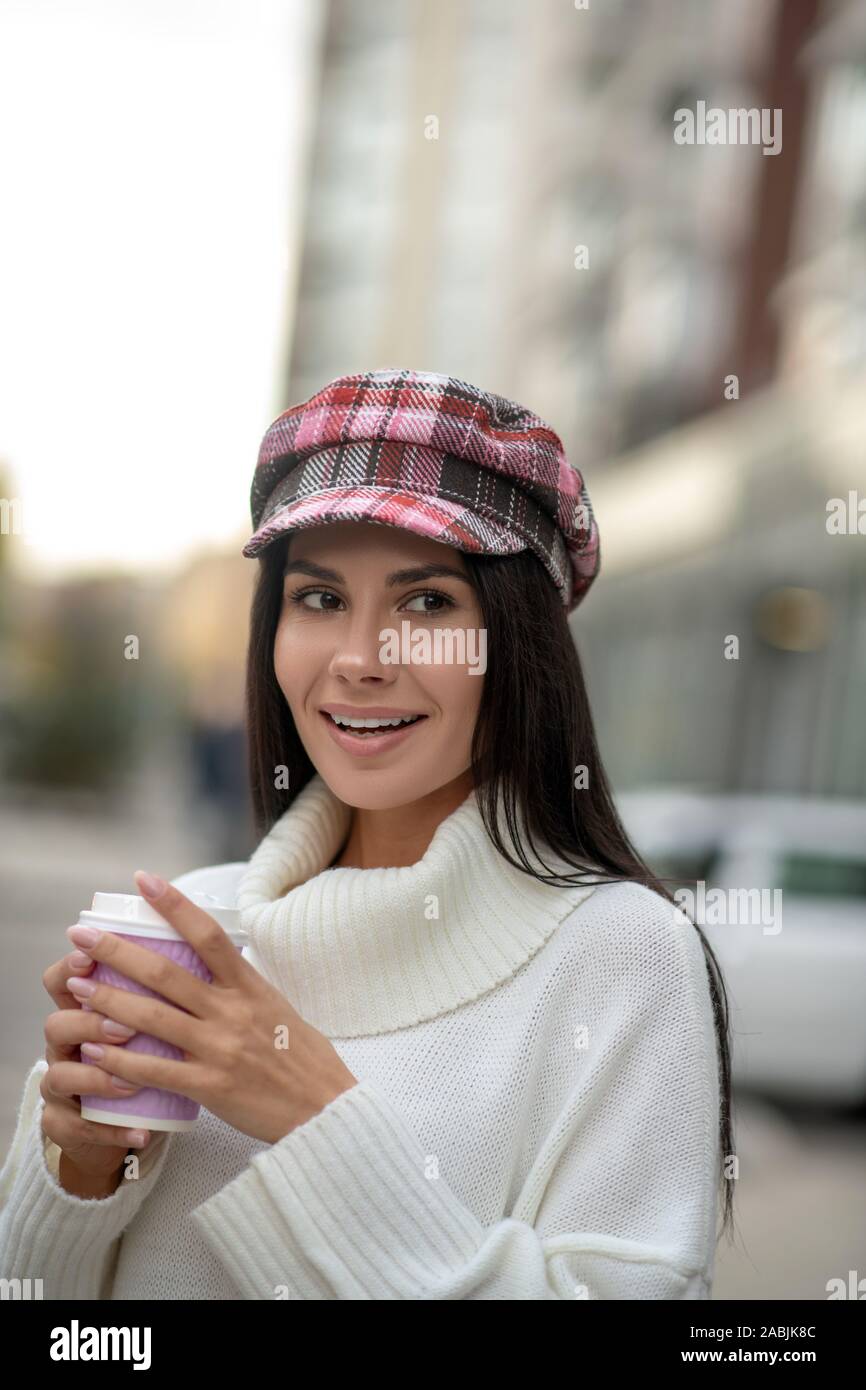 Pretty attractive woman drinking coffee on the street Stock Photo