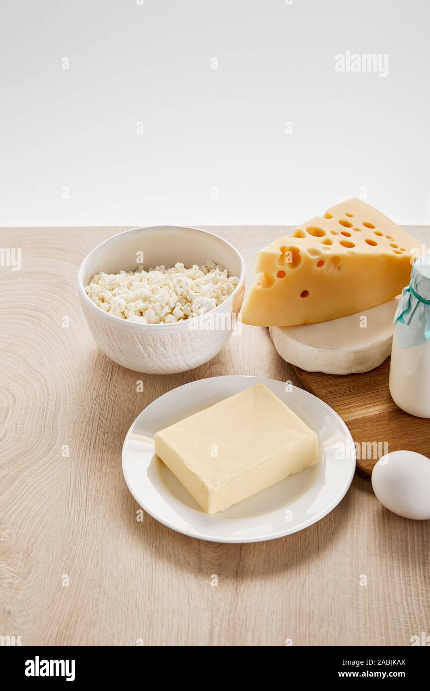 various fresh organic dairy products and egg on wooden table isolated ...