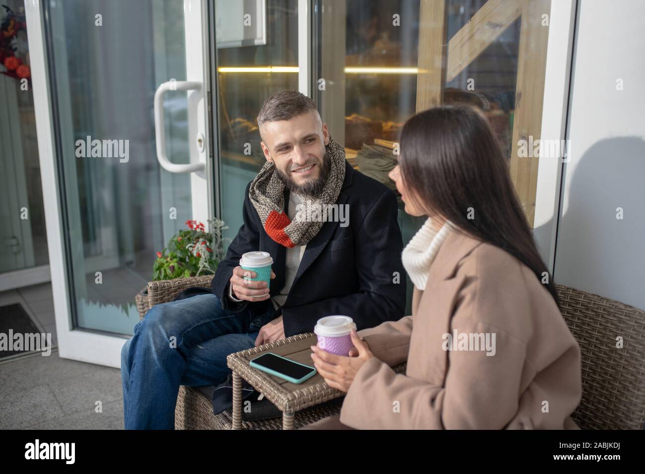 Pleasant young people talking to each other Stock Photo