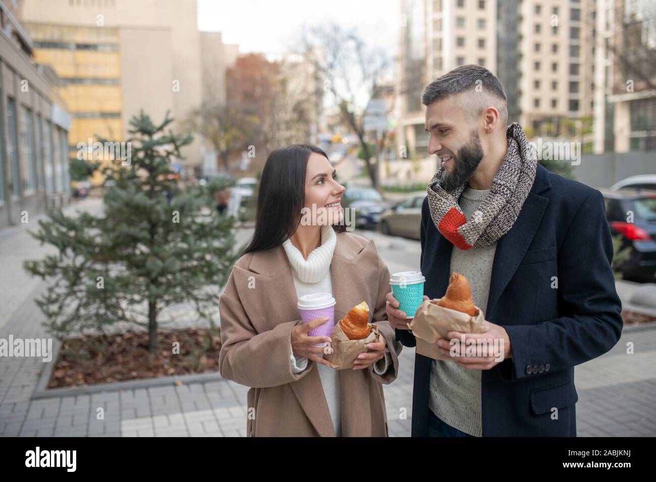 Delighted young couple having a snack together Stock Photo