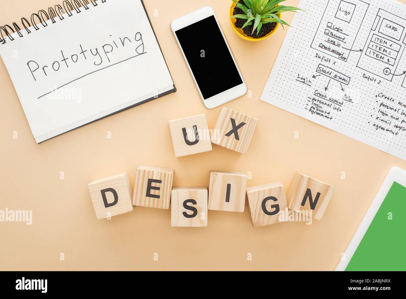 top view of gadgets near wooden blocks with ux design lettering ...