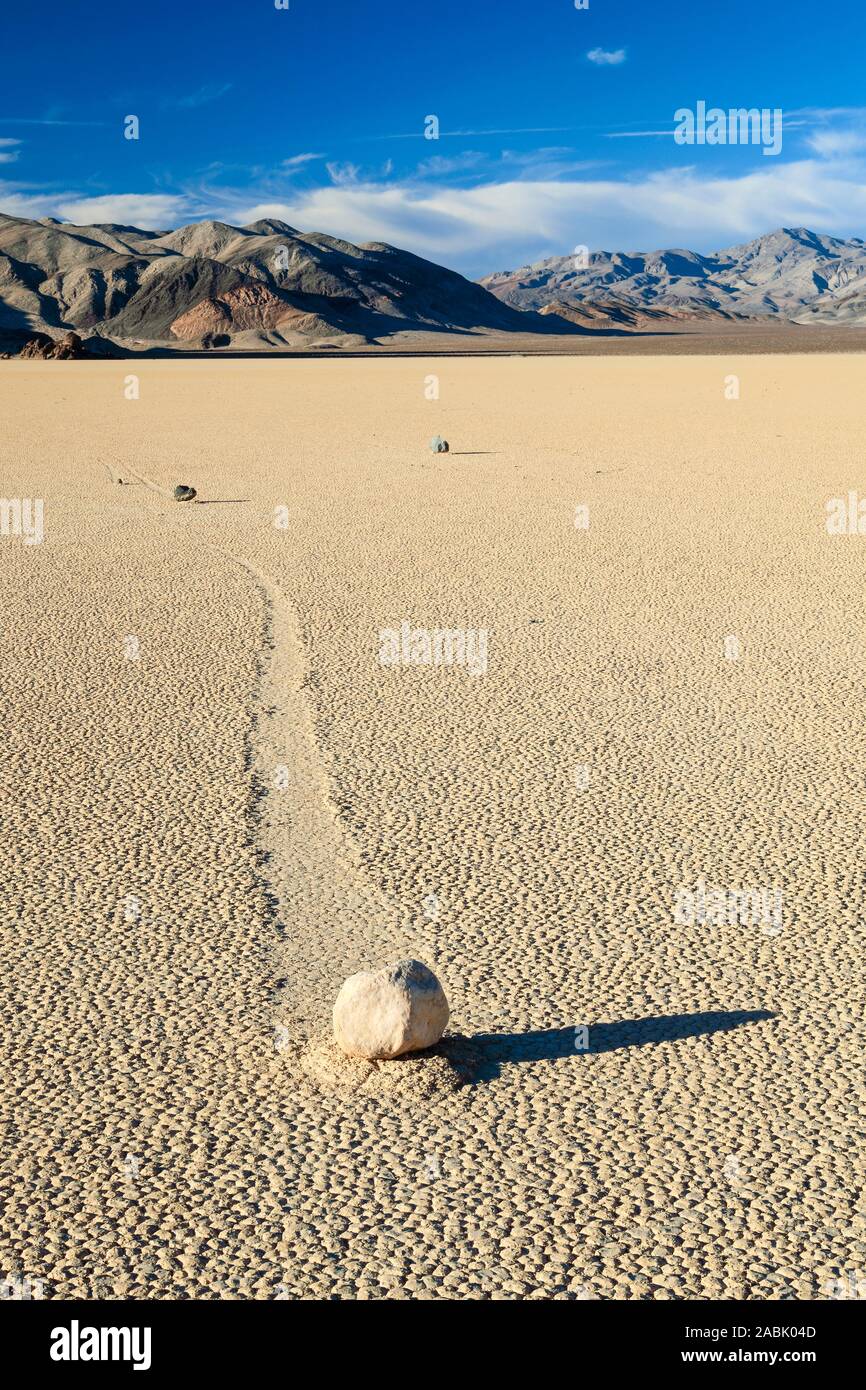 Meandering track created by one of the mysterious moving rocks at the Racetrack. The Racetrack is a dry lakebed  in the remote northern Death Valley. Stock Photo