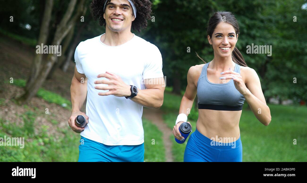 Couple jogging and running outdoors in nature Stock Photo - Alamy