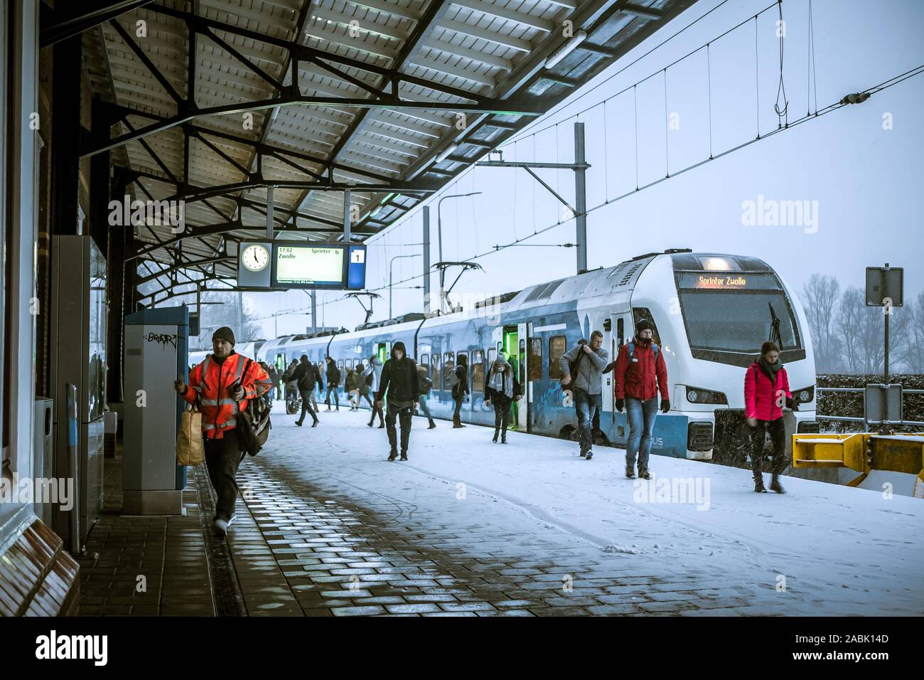 During late afternoon, a Keolis train from Zwolle has arrived in snow covered Kampen, Netherlands. Stock Photo
