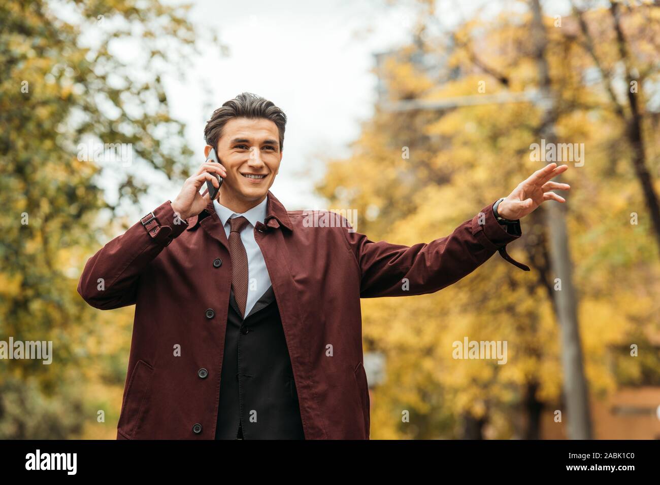 Smiling Is Catching Smiling businessman catching taxi hi-res stock photography and images ...