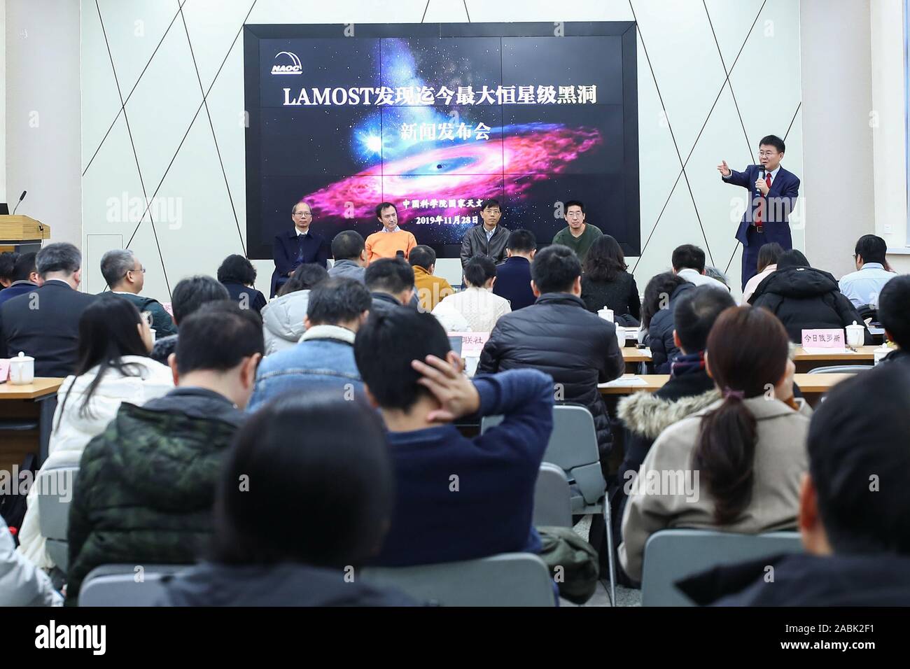 Beijing, China. 27th Nov, 2019. Liu Jifeng (1st R Back), deputy director-general of the National Astronomical Observatory of the Chinese Academy of Sciences (NAOC) and the first author of the study, speaks during a press conference of the black hole LB-1 discovered with the Large Sky Area Multi-Object Fibre Spectroscopy Telescope (LAMOST), in Beijing, capital of China, Nov. 27, 2019. Credit: Xinhua/Alamy Live News Stock Photo