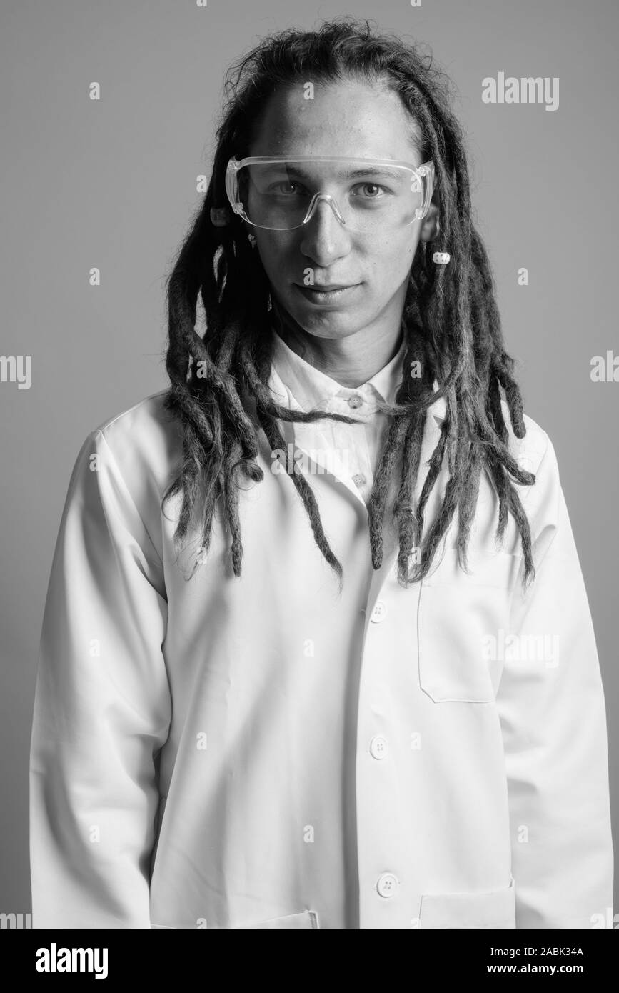 Young Man Doctor With Dreadlocks Wearing Protective Glasses
