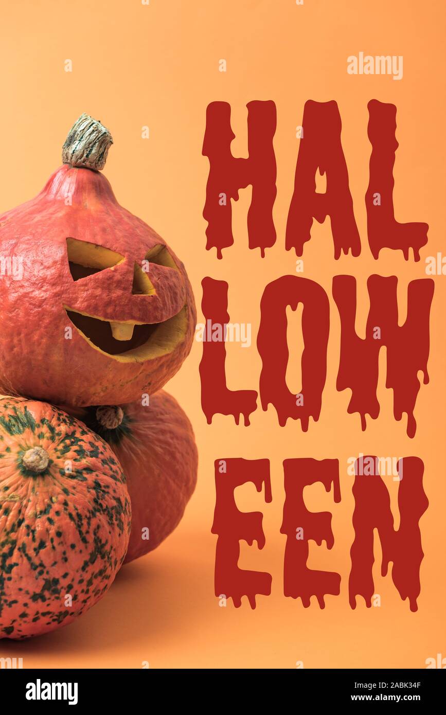 spooky carved Halloween pumpkin on orange background with bloody ...