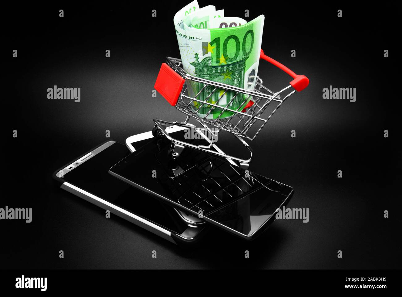 Euro banknotes and smartphones on a black background. Stock Photo