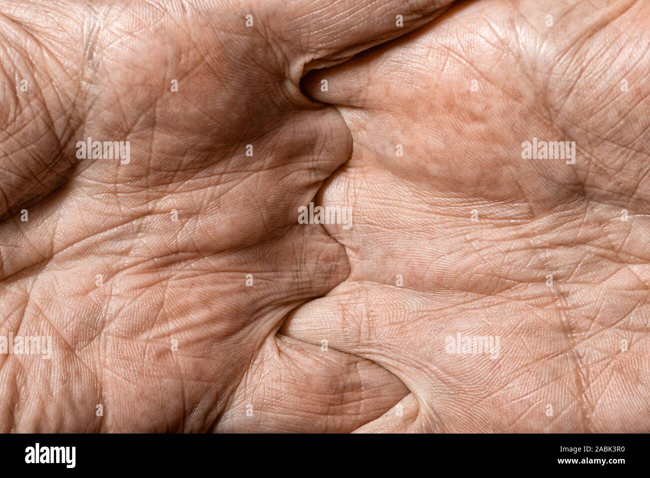 Color photo of senior man hands with crossed fingers Stock Photo