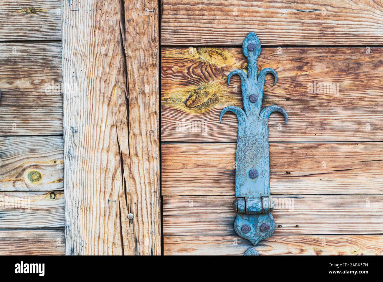 Fragment of wooden window shutters of wood house with vintage metal furniture, close up, horizontal image Stock Photo
