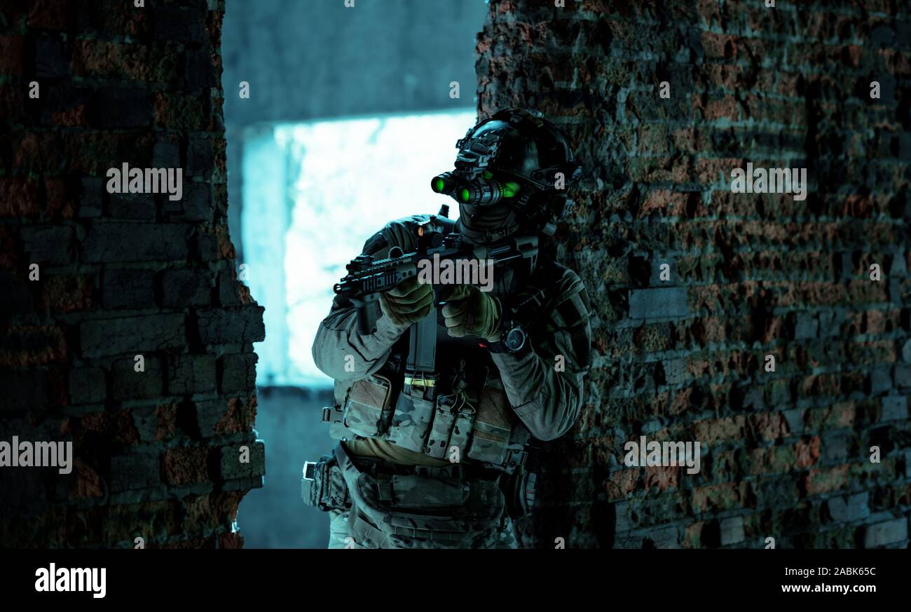 Airsoft man in uniform with machine gun and nightvision device on
