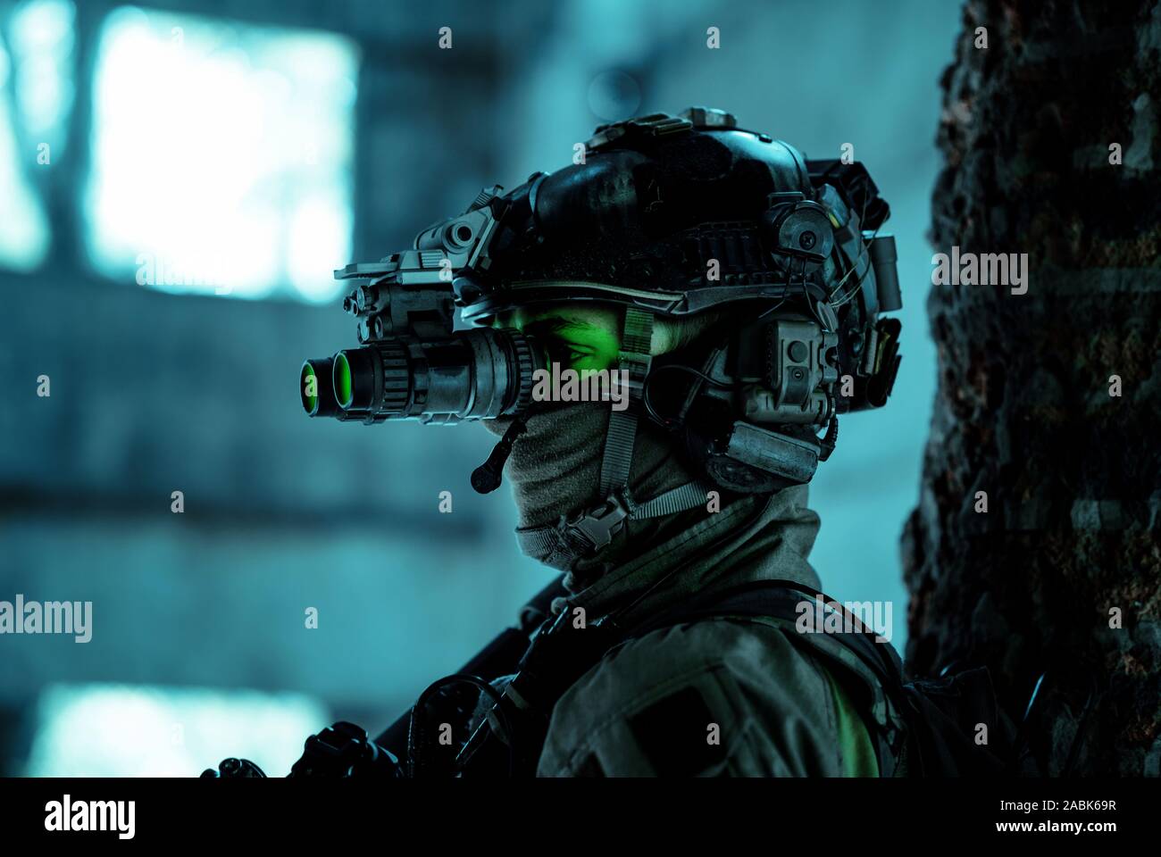 Airsoft man in uniform with machine gun and nightvision device on
