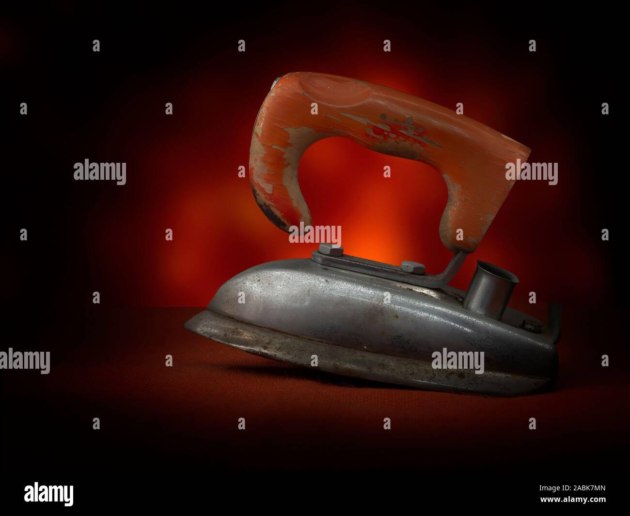 Vintage domestic electric iron. Real retro! Orange colour Stock Photo