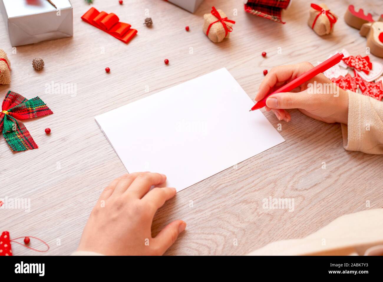 Download Blank Paper And Hand With Pen Surrounded With Christmas Gifts And Decorations Concept Of Writing Christmas And New Year Greetings Close Up Mockup Stock Photo Alamy PSD Mockup Templates
