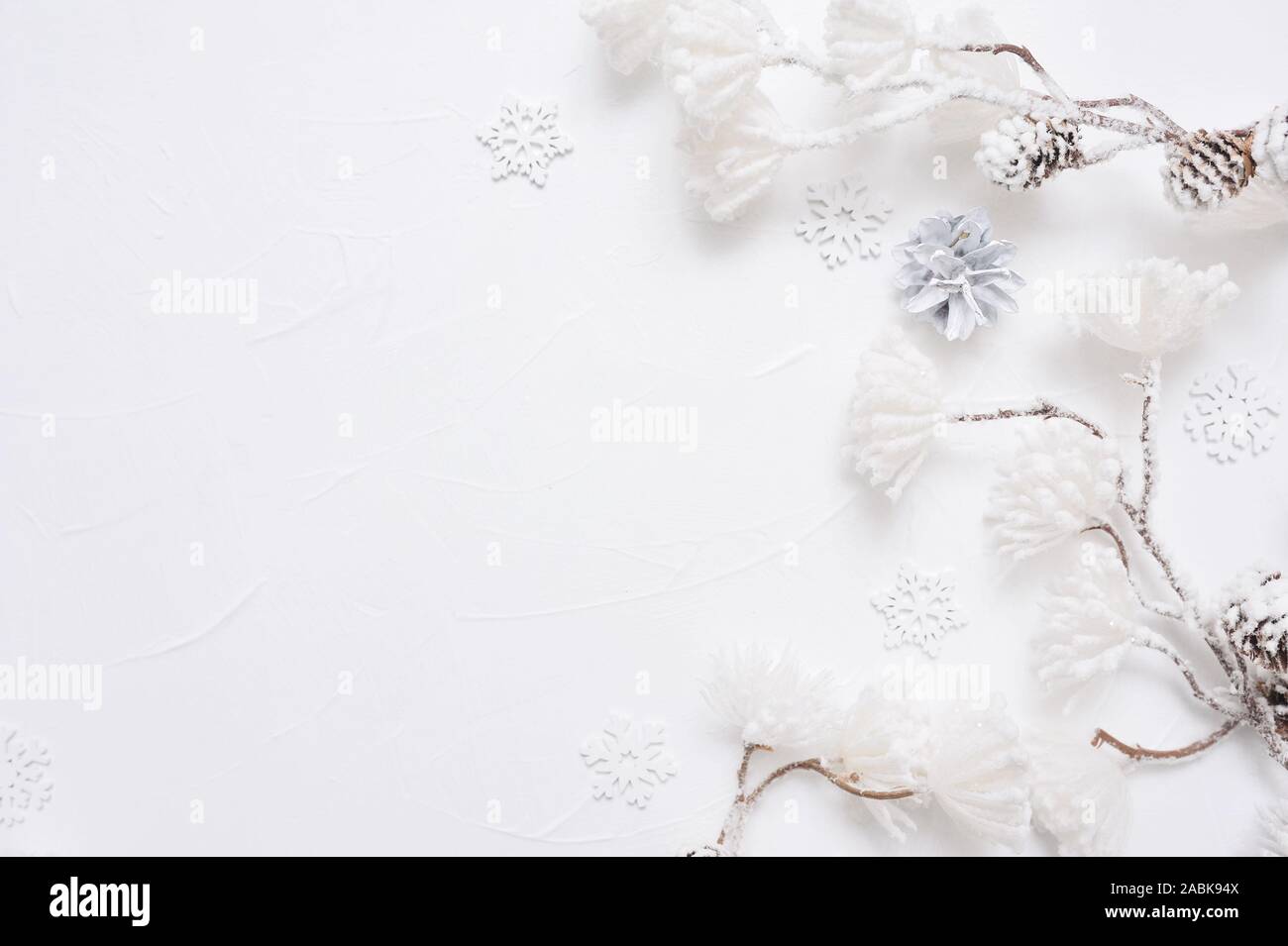 White Christmas border with cones, snowflakes and snown flowers. Xmas Wreath decoration with place for your text Stock Photo