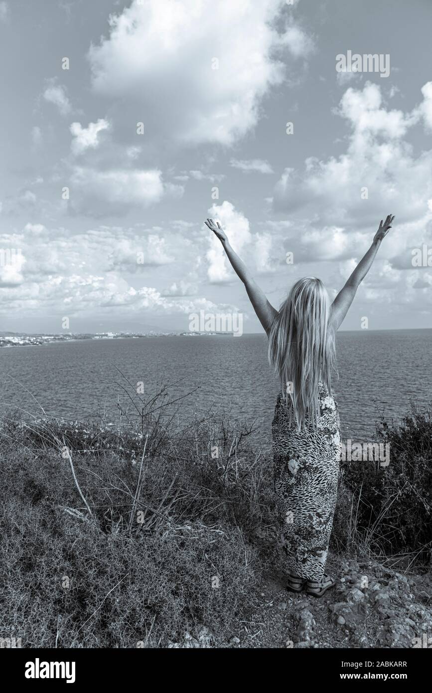 Slender Young Girl With Long Blonde Hair On The Mountain By The