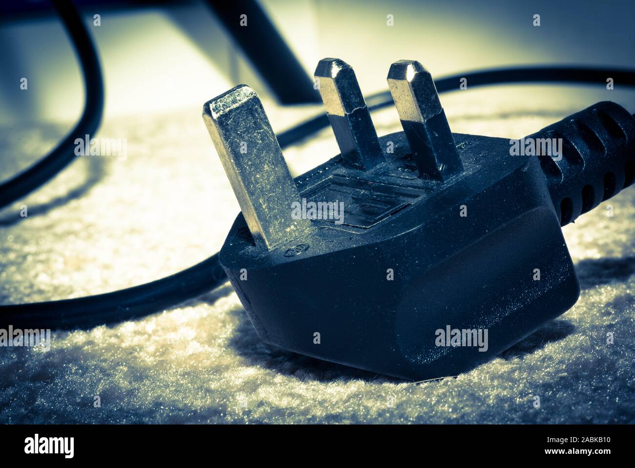 UK power plug isolated on dark blue background Stock Photo