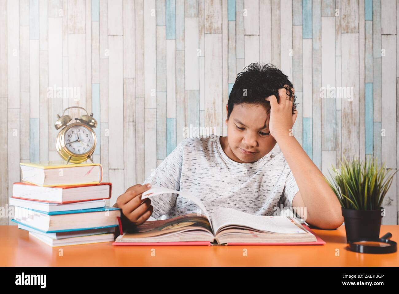 Stressed college student learning hard with books in exams preparation ...