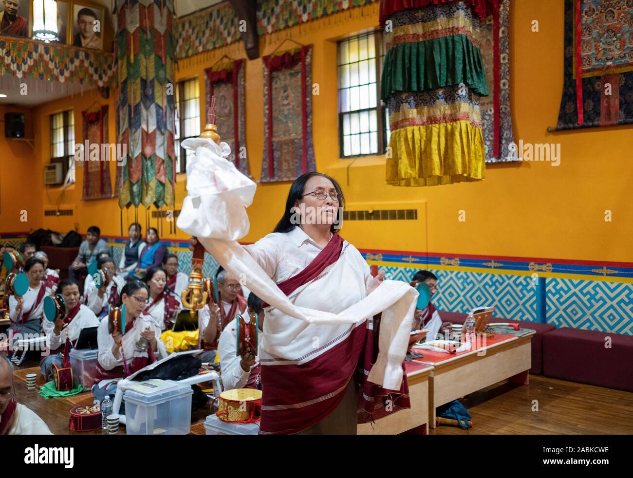 A devout Buddhist worshipper burns incense in a purification ritual at ...