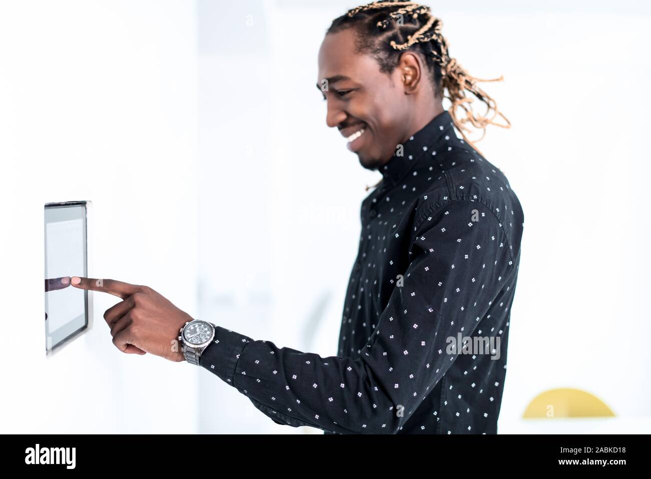 African man using smart home screen control system Stock Photo