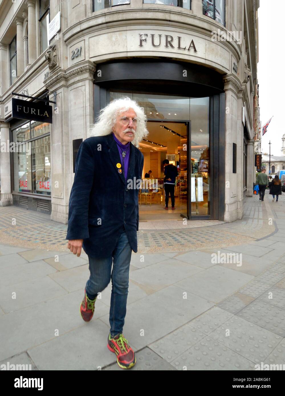 London, England, UK. Older man with long white hair walking past Furla store in Regent Street Stock Photo