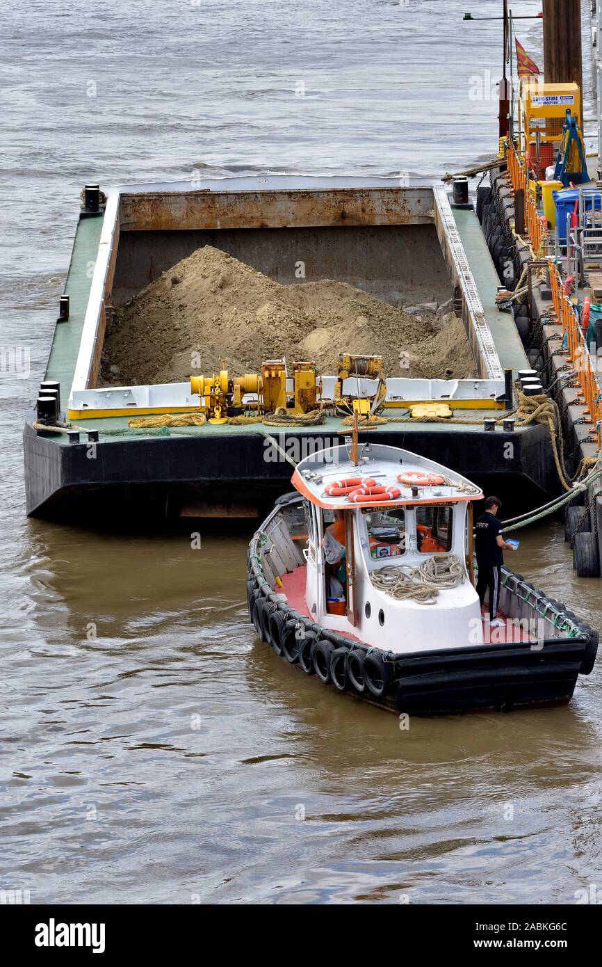 London, England, UK. Thames tug boat and barge full of sand Stock Photo