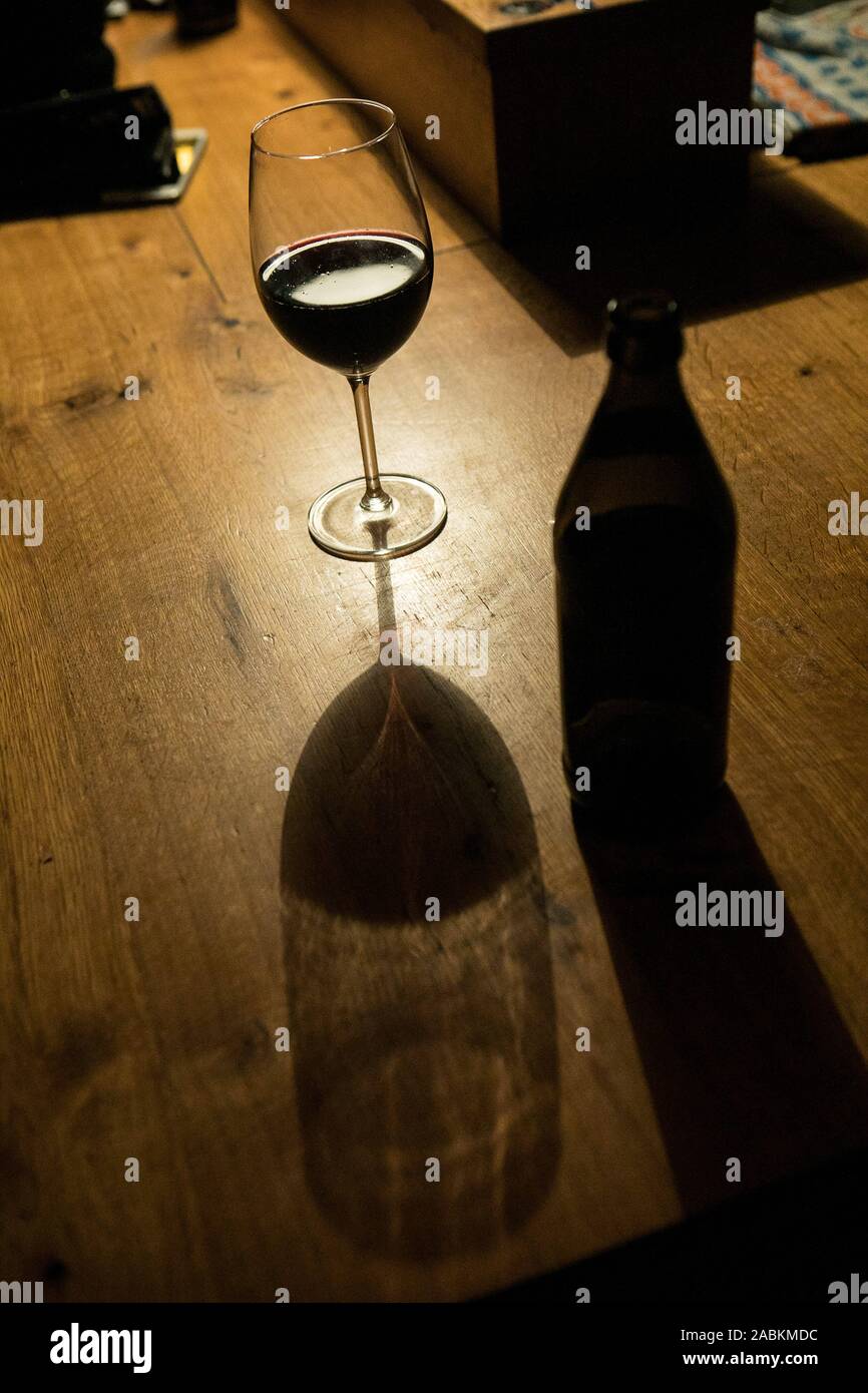 Wine glass and beer bottle in the bar "Die Karotte" in the backyard of