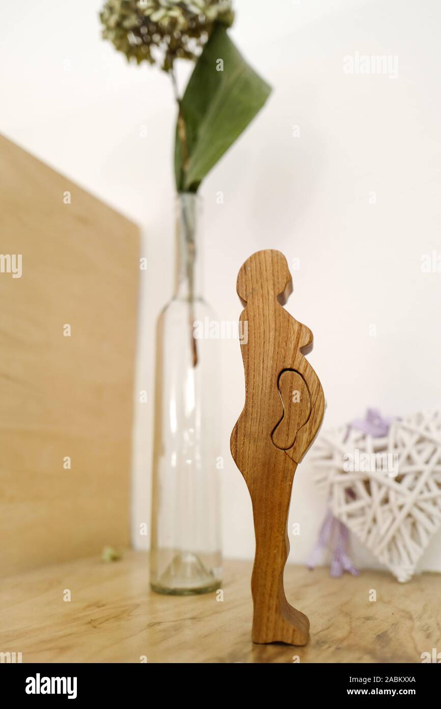 A wooden figure of a pregnant woman stands in one of the counselling rooms of the counselling centre for natural birth in Häberlstraße in Munich. [automated translation] Stock Photo