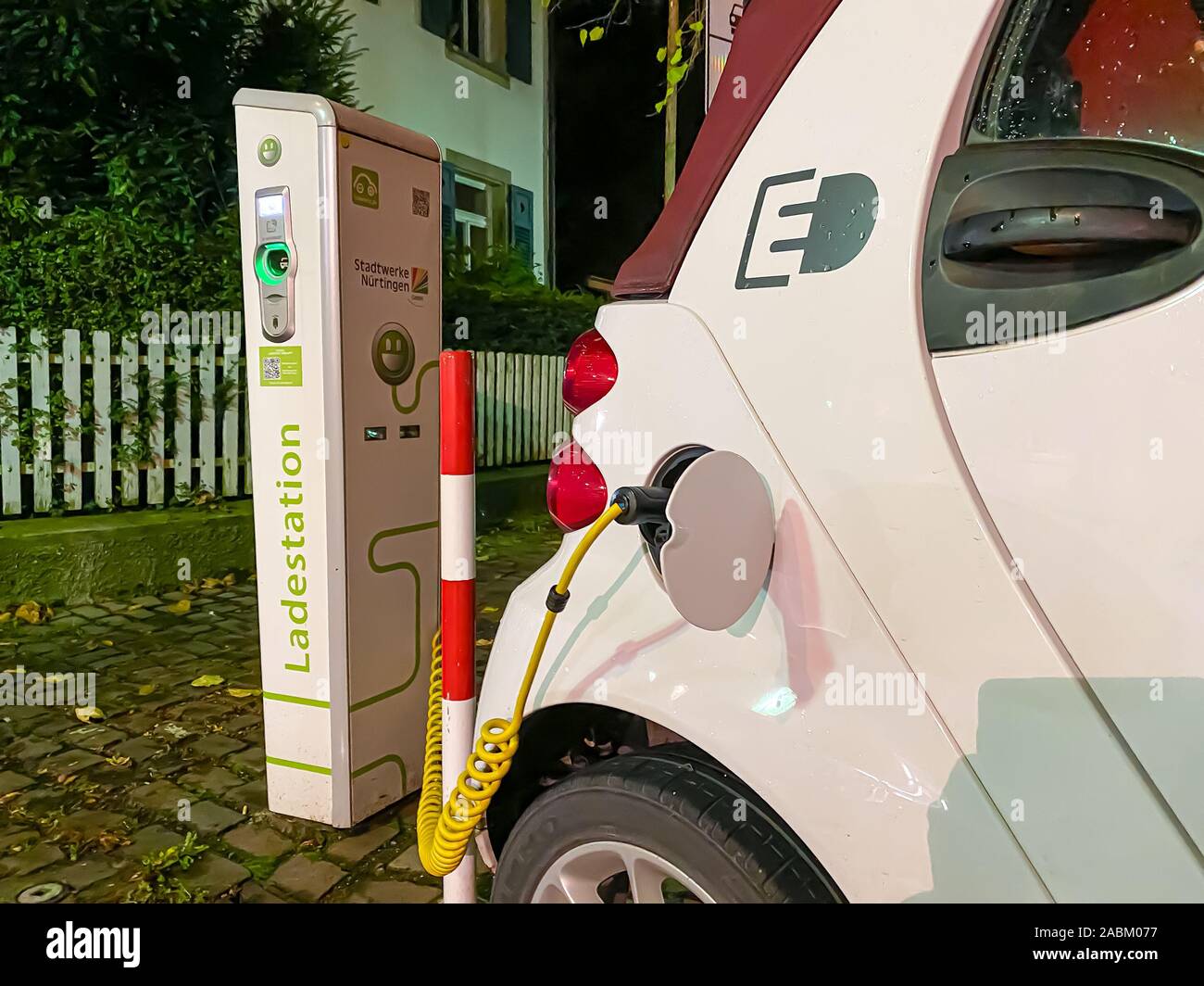 Small electric rent car on a charge base, Nürtingen, Germany Stock Photo