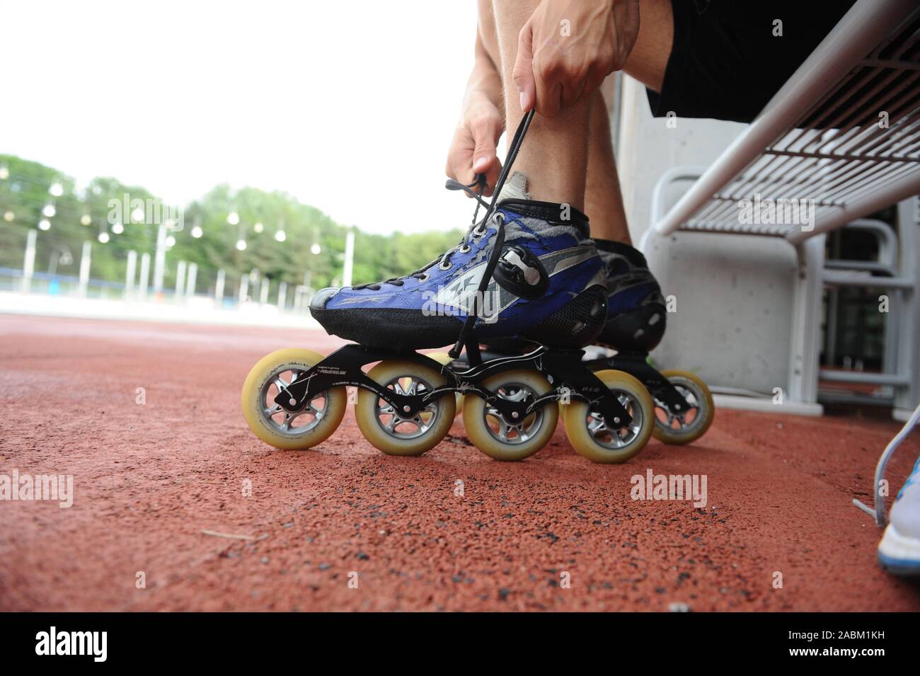 A man ties up his inline skates at the ice and fun sports centre in Berg am  Laim /Trudering. [automated translation] Stock Photo - Alamy