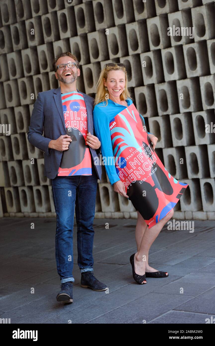 The director of the Munich Film Festival, Diana Iljine, and the artistic director Christoph Gröner, wrapped in the poster of the 37th Munich Film Festival. [automated translation] Stock Photo