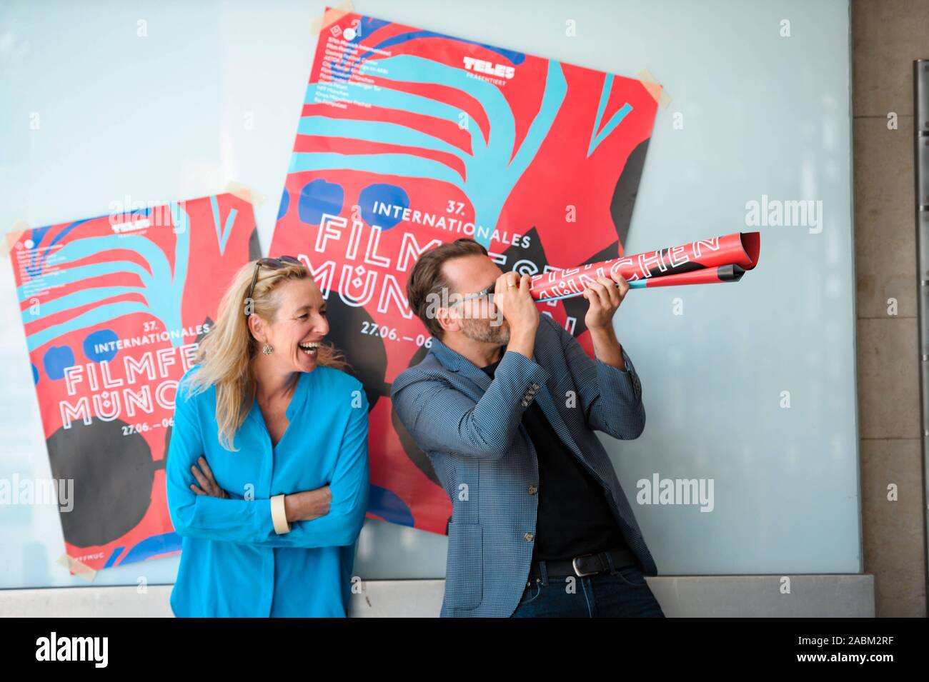 The director of the Munich Film Festival, Diana Iljine, and the artistic director Christoph Gröner, with the poster of the 37th Munich Film Festival. [automated translation] Stock Photo