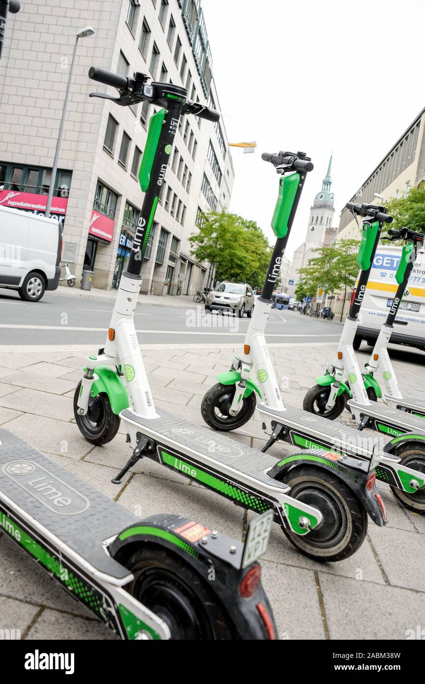 On a sidewalk parked electric scooter of the supplier Lime in Munich.  [automated translation] Stock Photo - Alamy