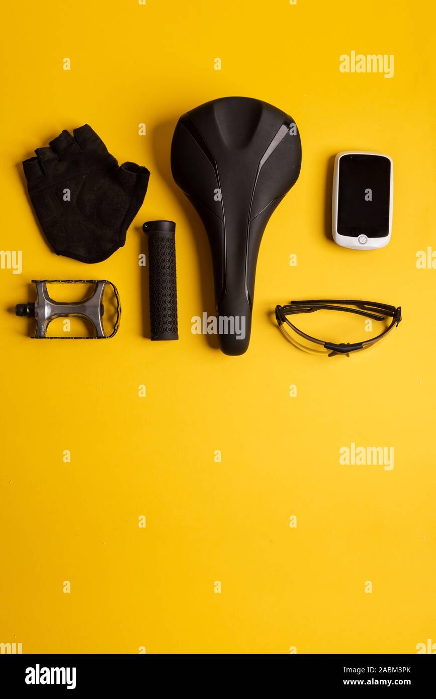Bicycle, Cycling accessories on the yellow background. view from above