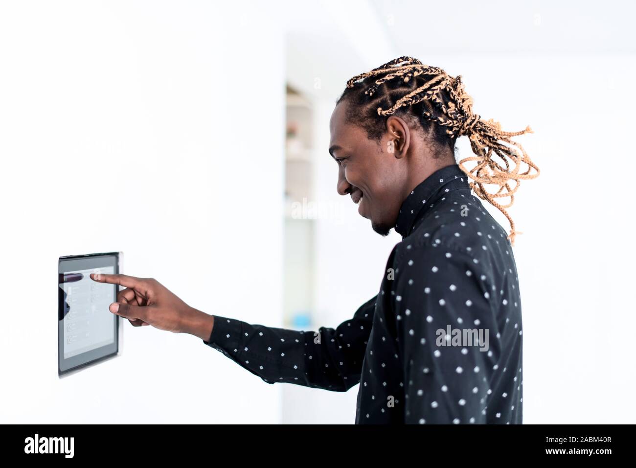 African man using smart home screen control system Stock Photo