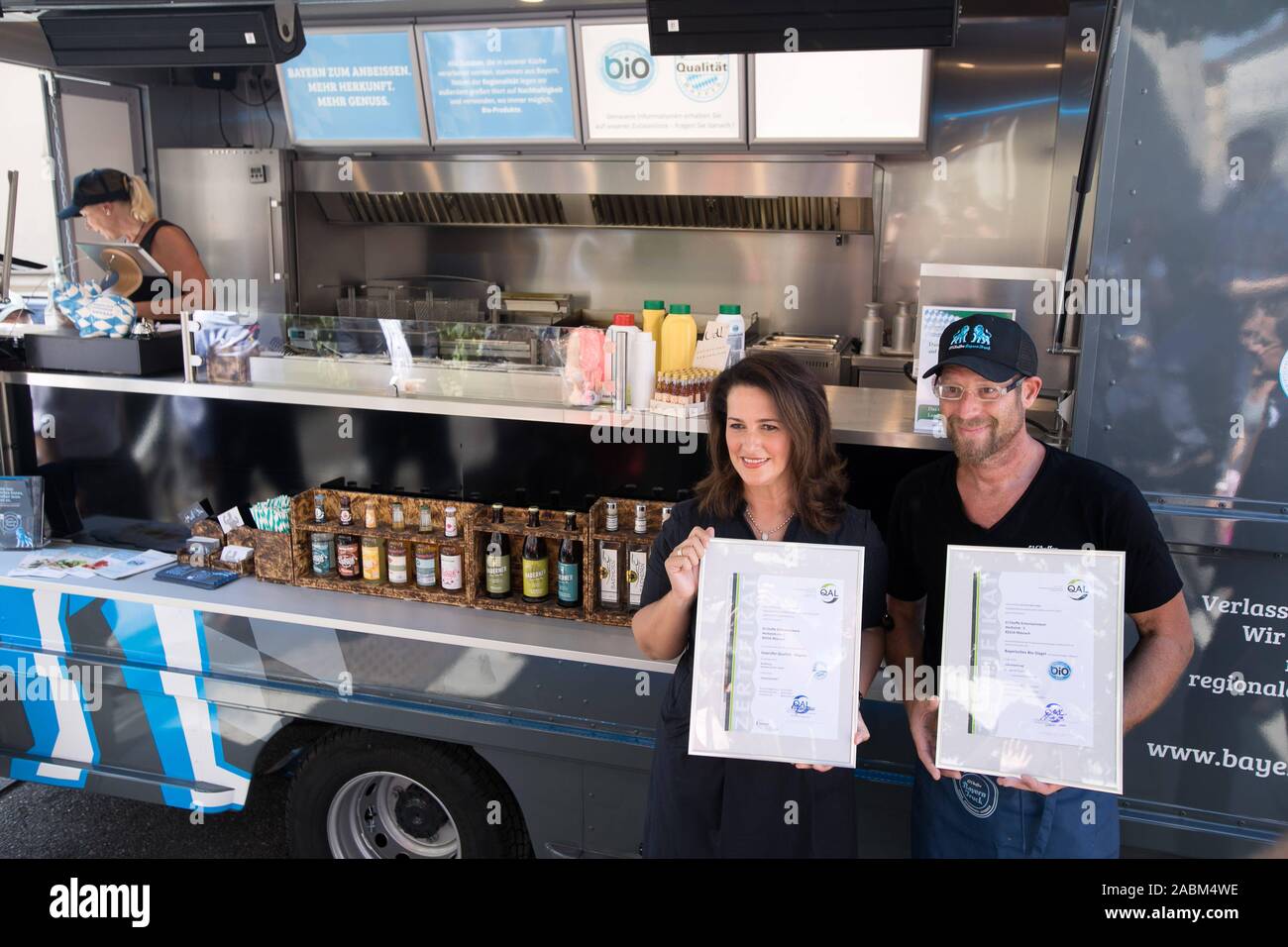 Michaela Kaniber (CSU), Minister of Nutrition, is sending a Bavarian Food Truck on its way from Galeriestraße at the corner of Ludwigstraße in Munich to inspire young people in Bavaria to buy regional food. In the picture she shows with Lars Mrosek from the Foodtruck the certificates 'Bayerisches Bio-Siegel' and 'Geprüfte Qualität - Bayern'. [automated translation] Stock Photo