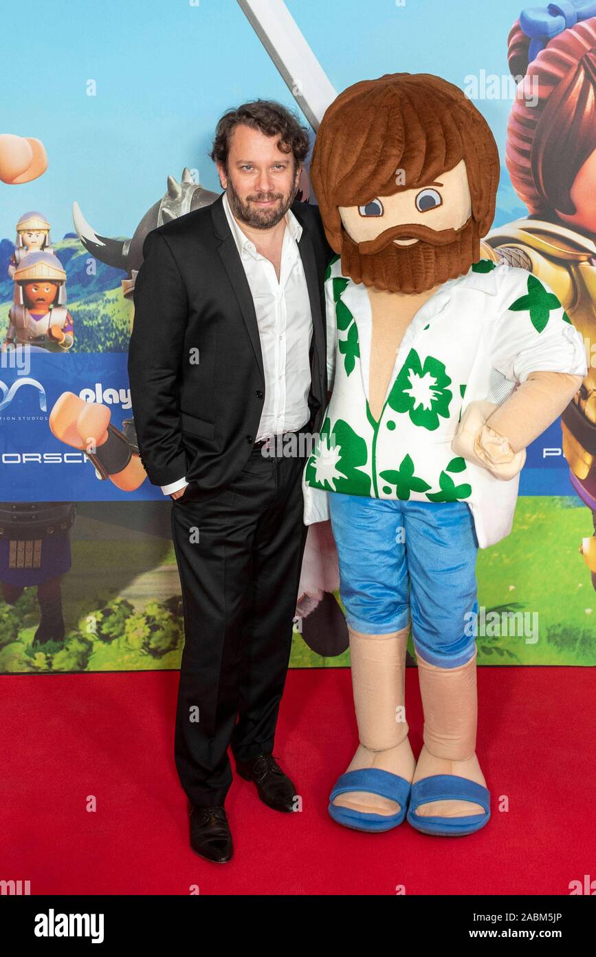 The actor in the Playmobil film Christian Ulmen poses next to her character  Del for a photo on the red carpet at the film premiere on Sunday, August 4,  2019 at the