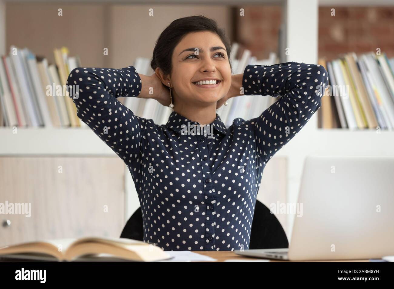 Happy indian girl relaxing after finishing school project. Stock Photo