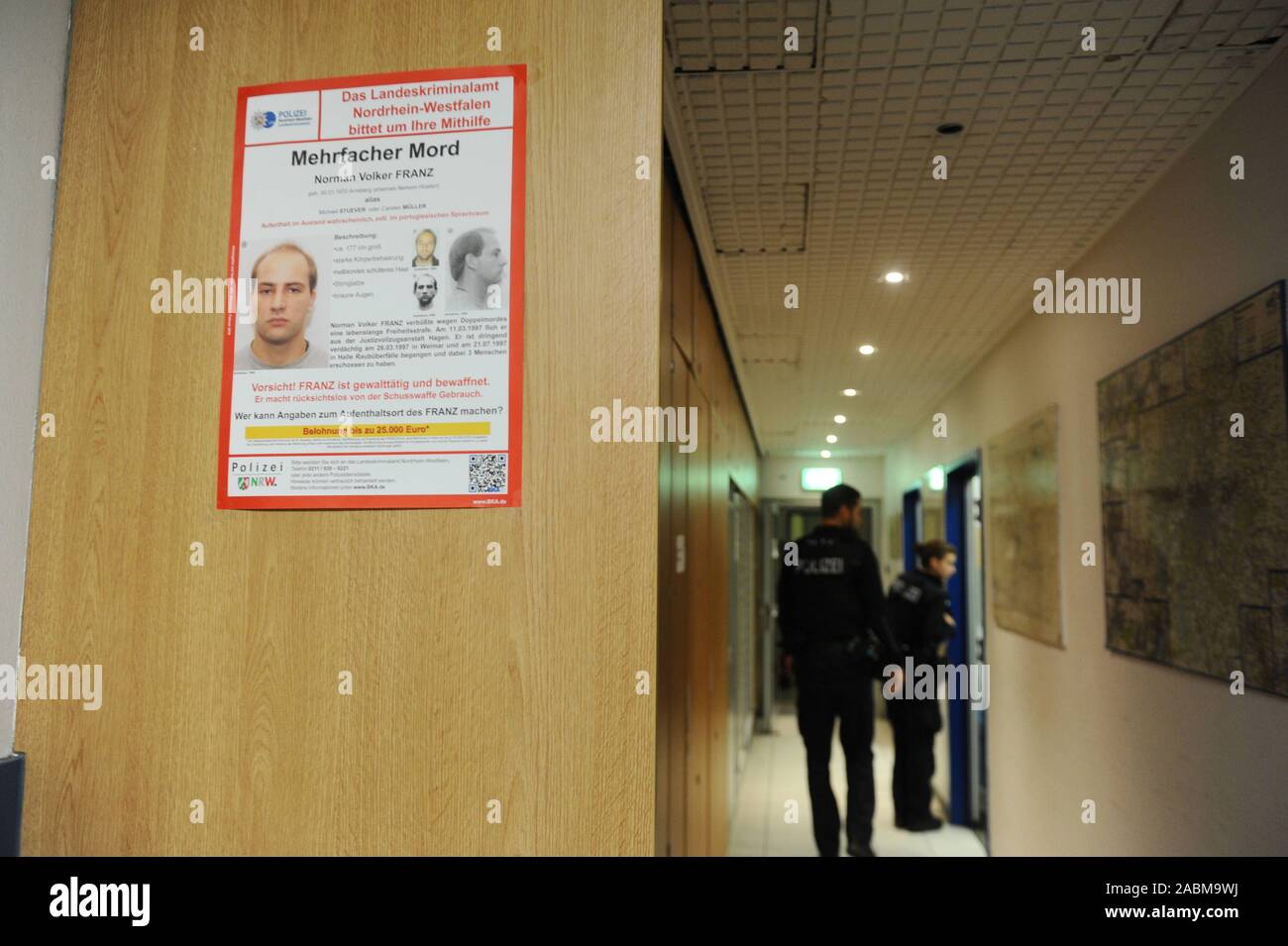 Members of the Federal Police on duty at night duty at Munich Central Station. In the foreground hangs a wanted poster. [automated translation] Stock Photo