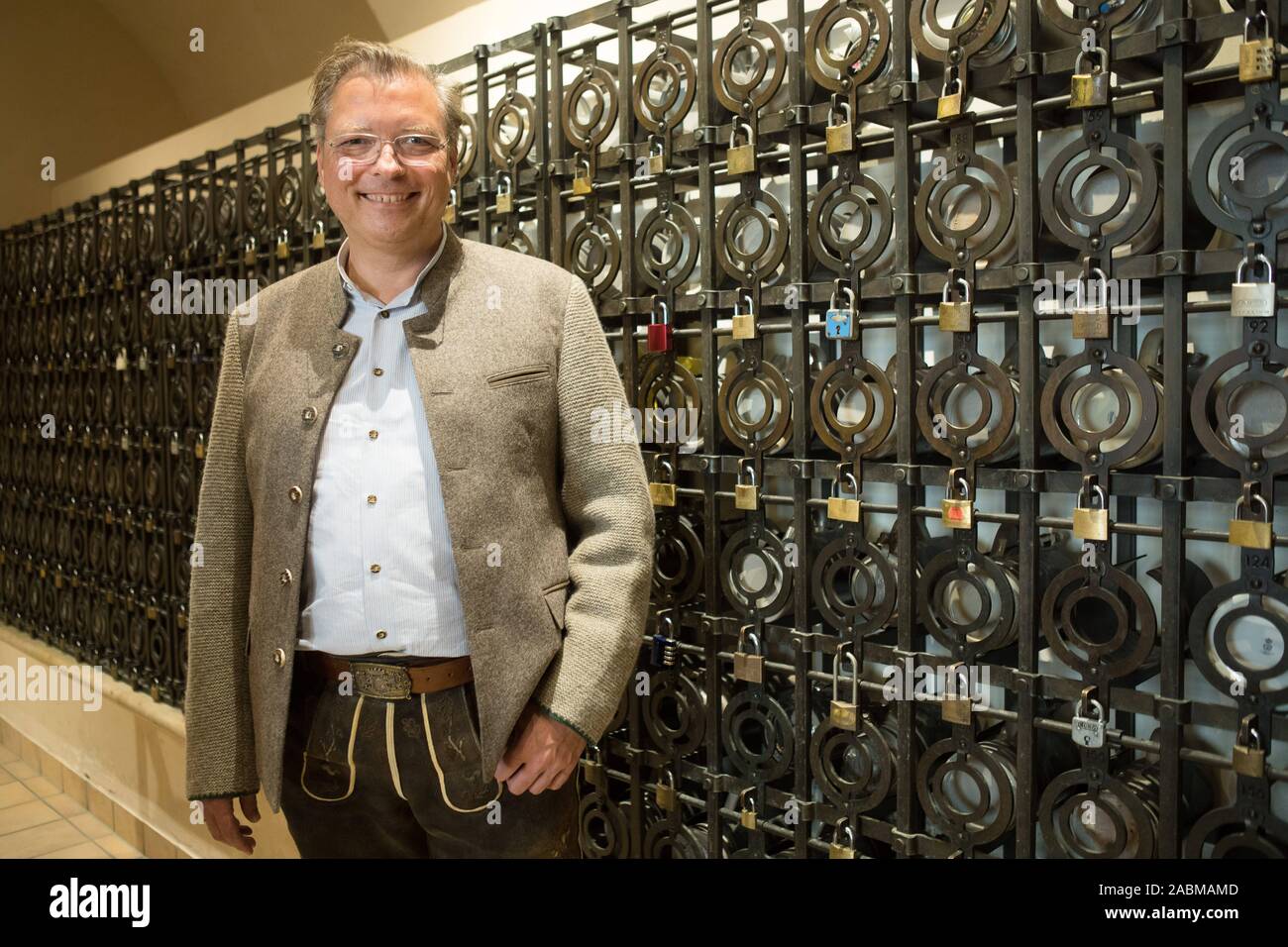 Landlord Wolfgang Sperger In Front Of A Beer Mug Safe Shelf In The