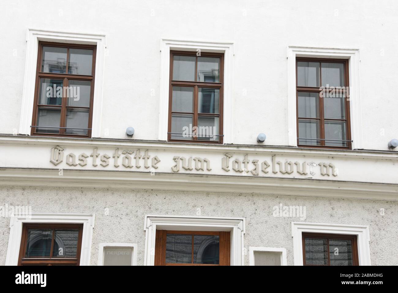 An old lettering on the façade of the house in Inner Wienerstraße refers to the former restaurant zum Tatzelwurm. [automated translation] Stock Photo