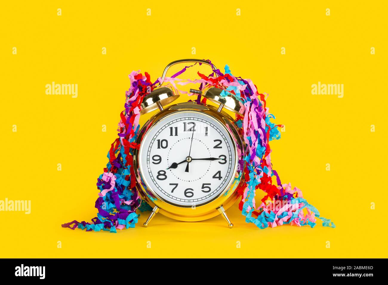 Old alarm clock on a yellow background Stock Photo