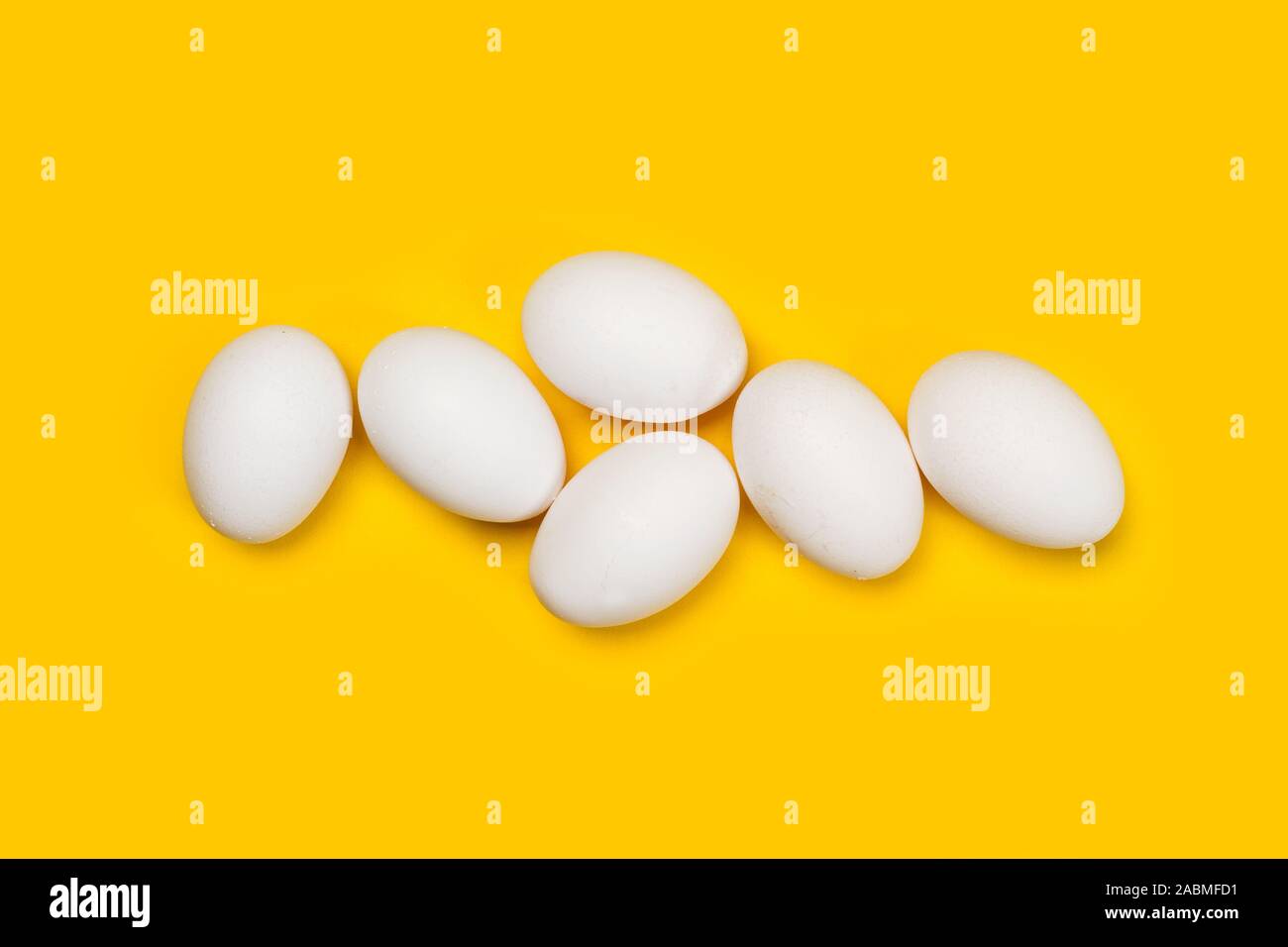 White eggs on a yellow background Stock Photo