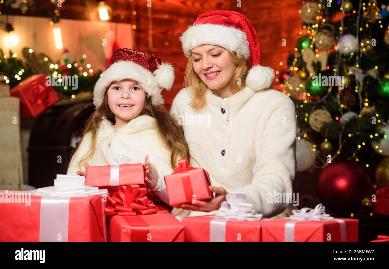 Winter Holiday Gifts For Girls Mom And Child With Gift Boxes Surprise For Daughter Happy Holidays New Year Tradition Boxing Day Wrapped Gifts Near Christmas Tree Preparing Gifts For Family Stock Photo