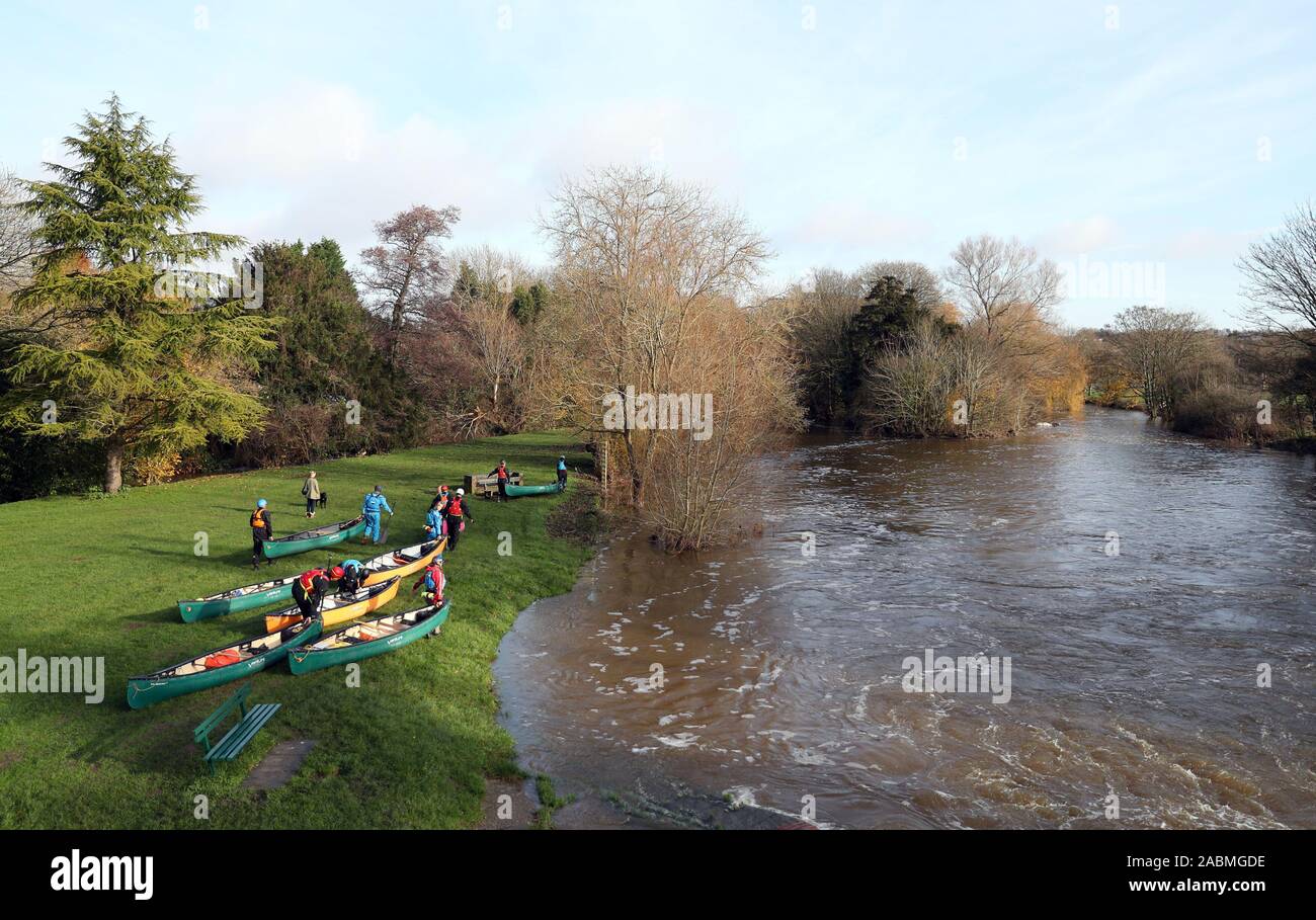 Silt-laden water rushing over a weir on the River Stour Blandford Dorset  England UK Stock Photo - Alamy