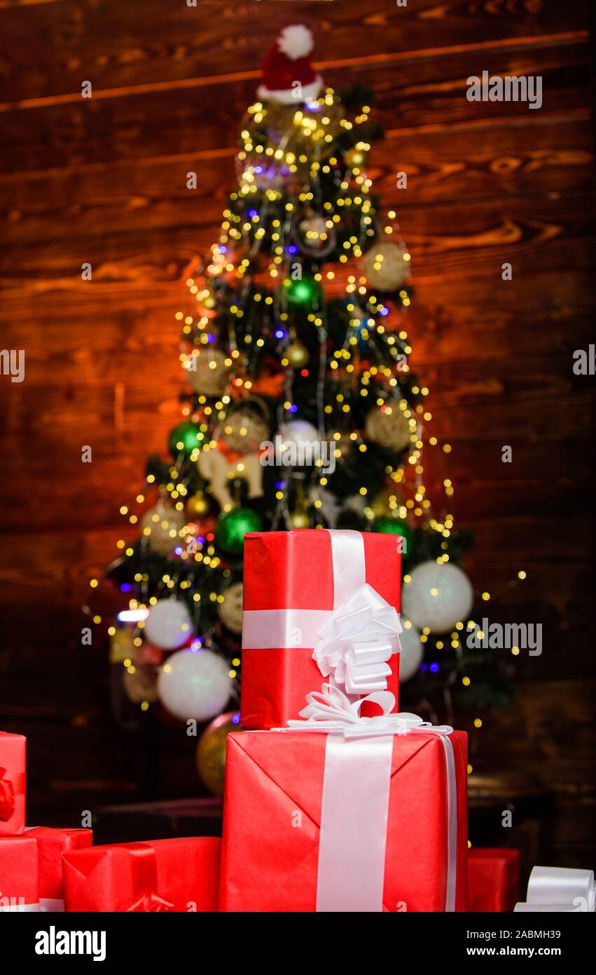 Time to celebrate. happy new year. celebrate xmas at home. winter holiday shopping. shopping sales. gift delivery. surprise from santa. Christmas online shopping. present boxes at christmas tree. Stock Photo
