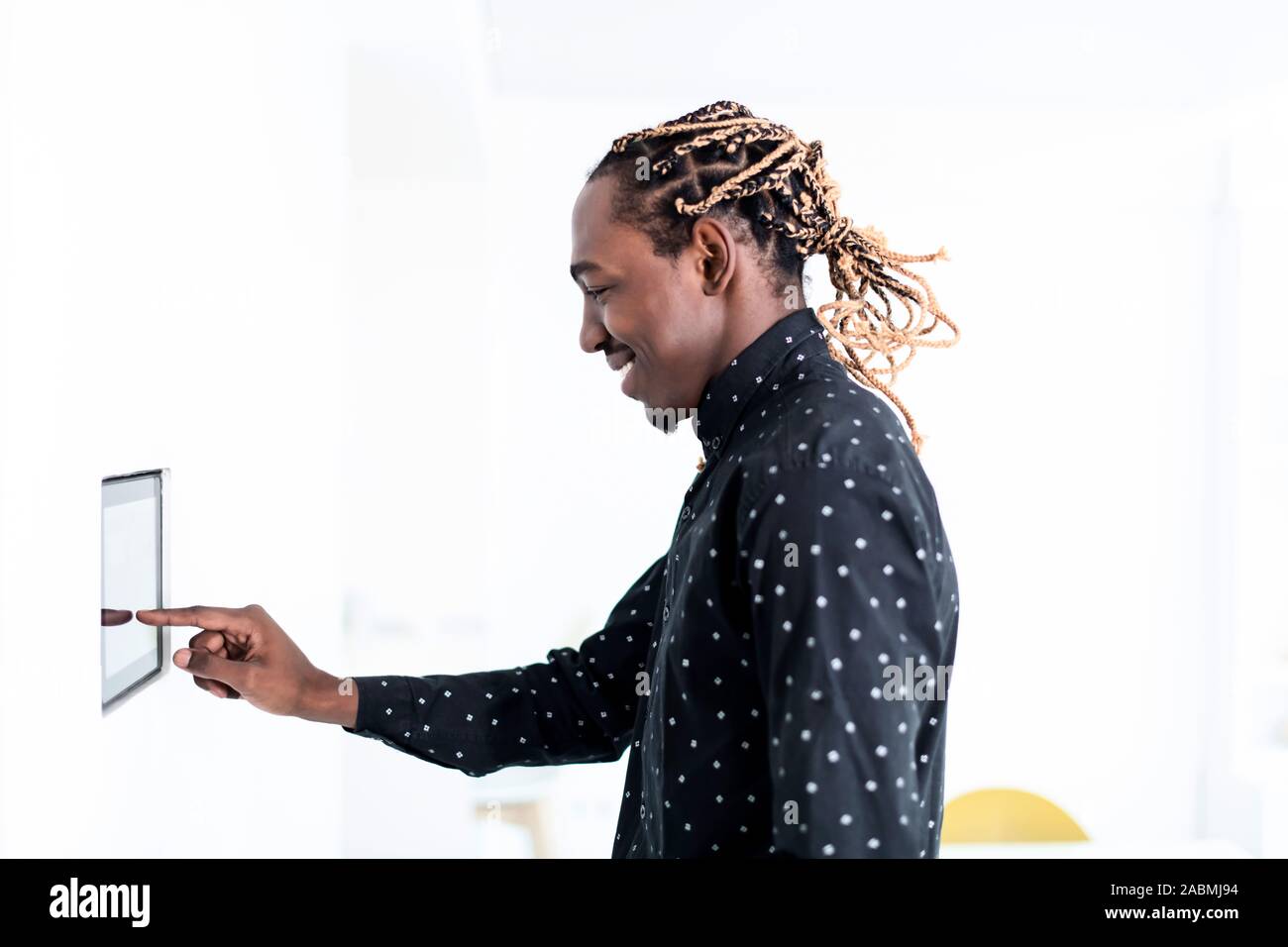 African man using smart home screen control system Stock Photo